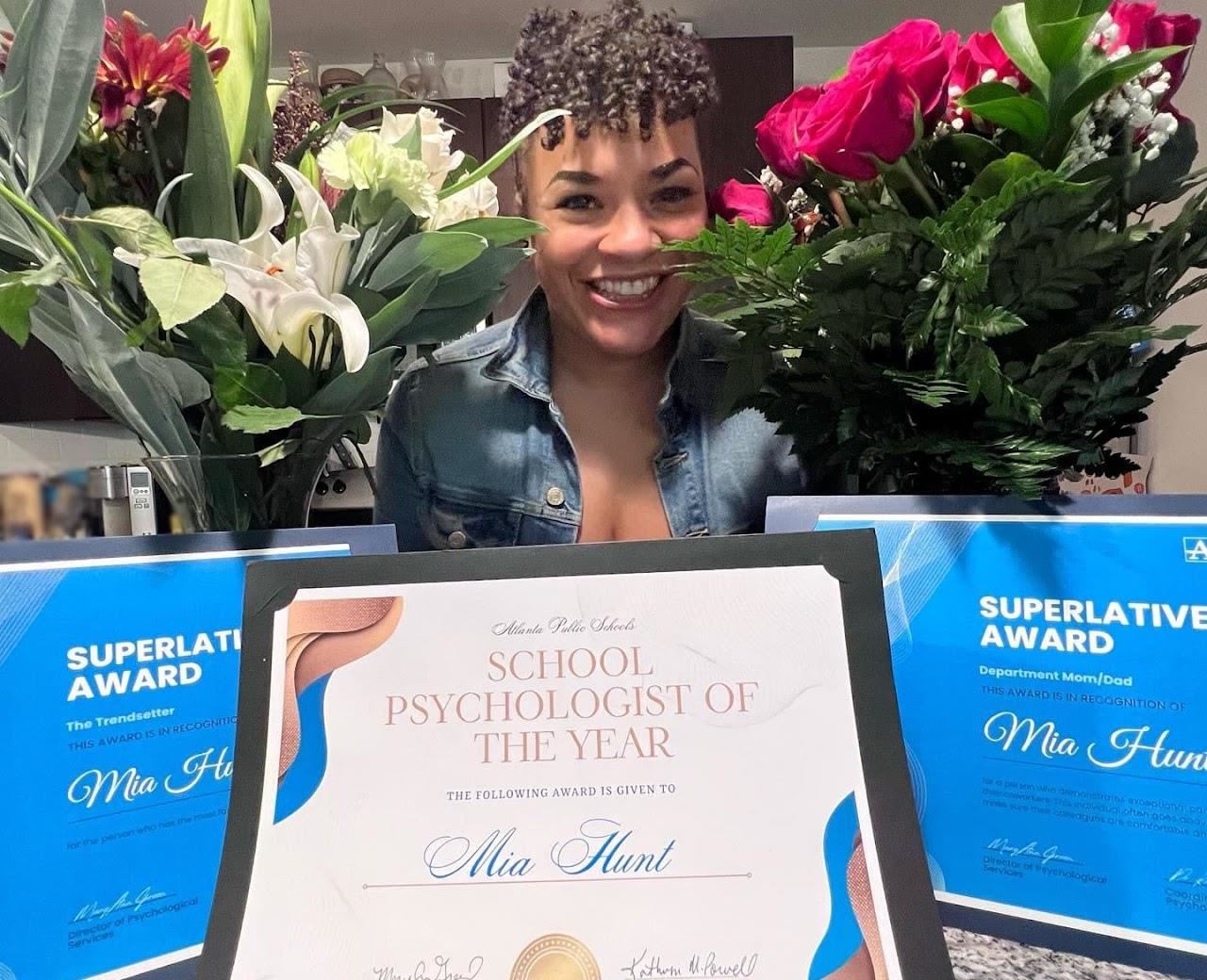 Mia Hunt accepting her certificate as School Psychologist of the Year